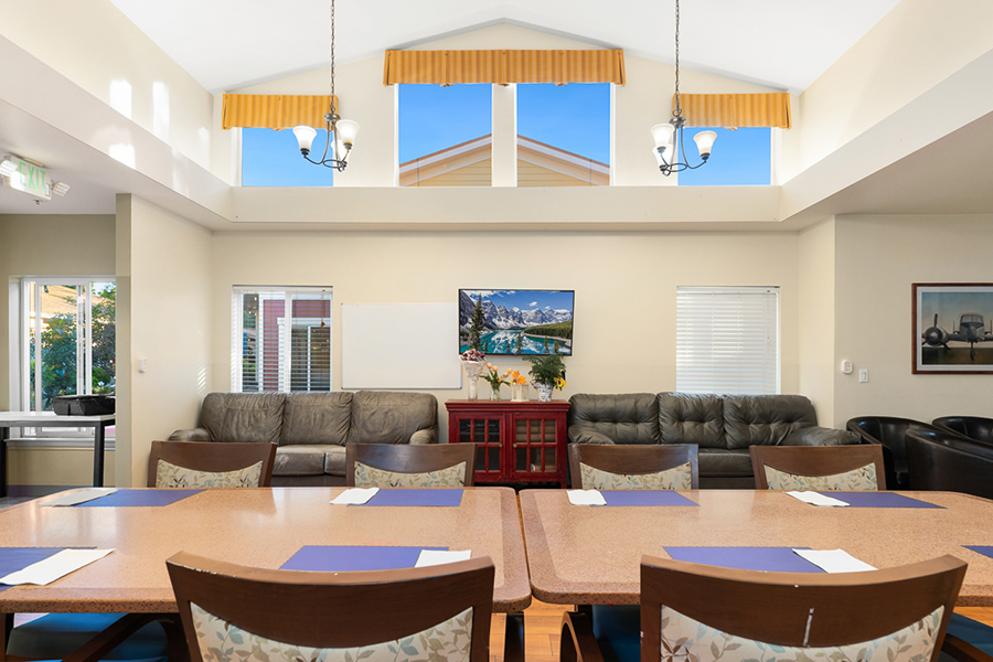 Bright, spacious lounge with seating and scenic wall art.