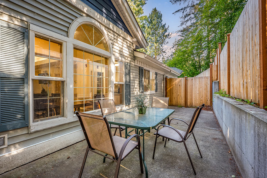 Cozy outdoor patio with a table and chairs.