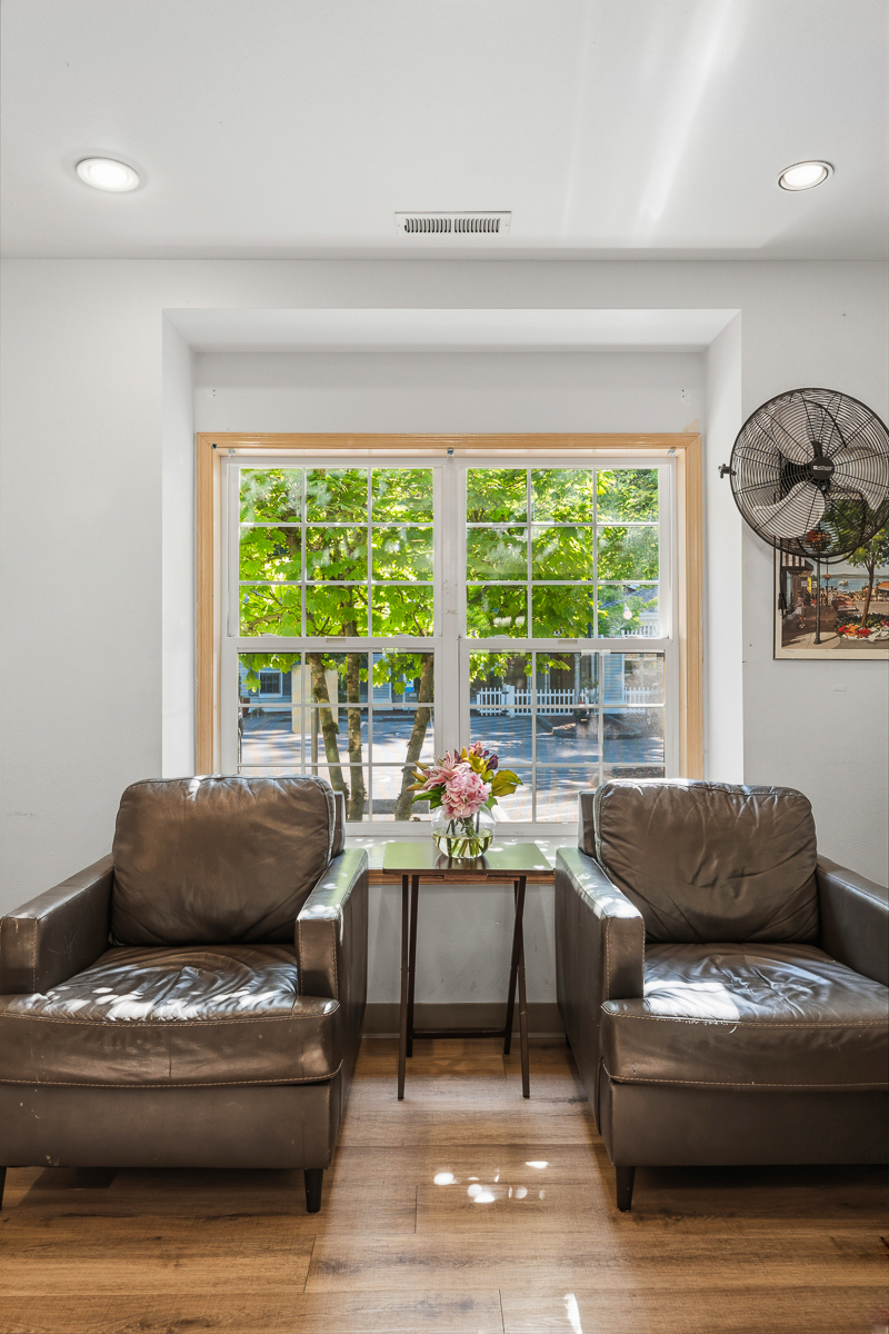 Cozy seating area with plants and natural light.