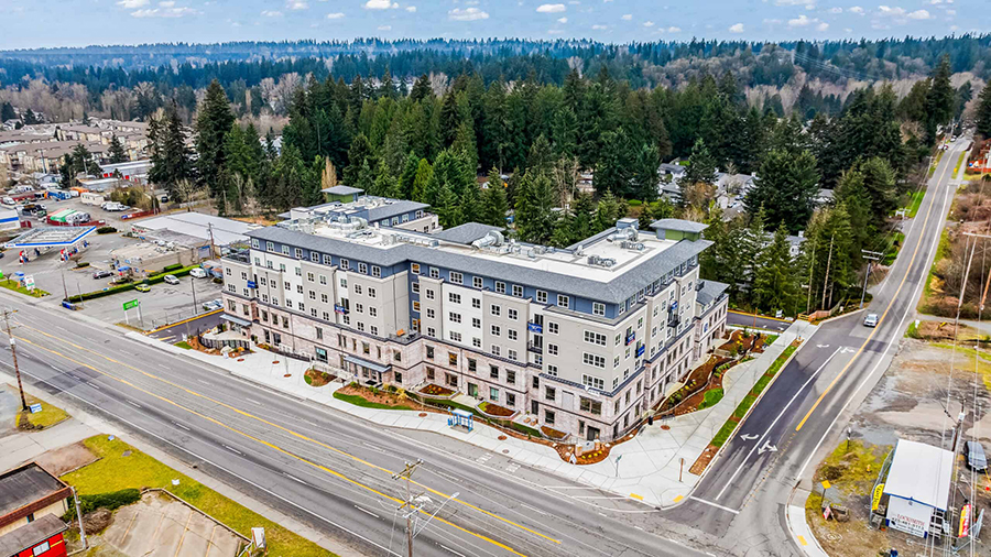 Aerial view of a hotel near a forested area.