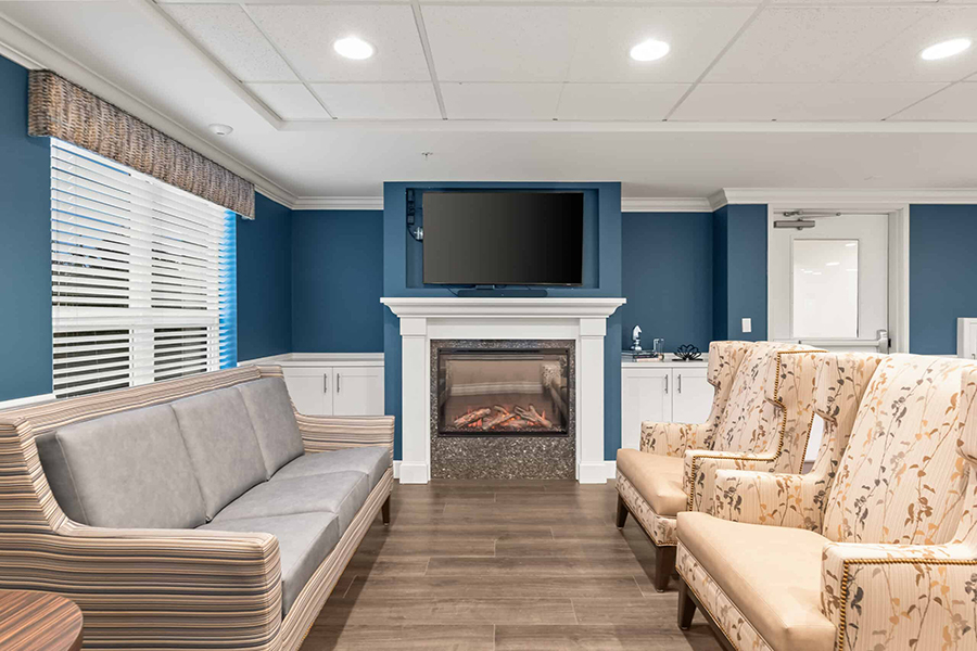 Cozy living area with modern furniture and fireplace.