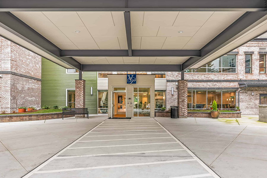 Modern entrance of a building with covered walkway.