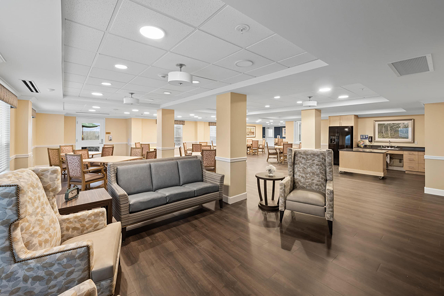 Spacious, modern common area with sofas and dining tables.