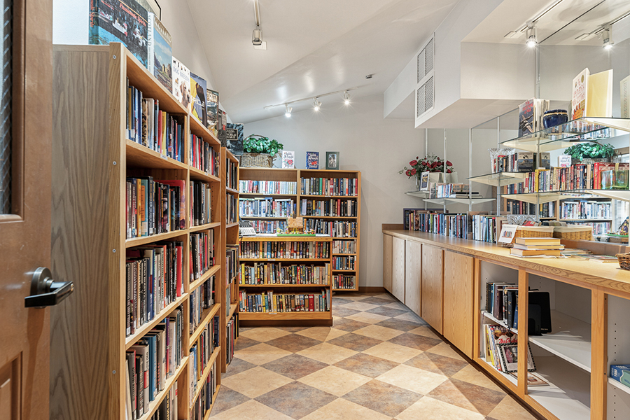 Cozy space filled with books and wooden shelves.