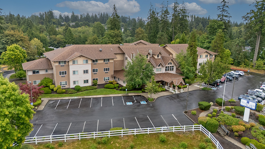 Aerial view of a multi-story building surrounded by trees.