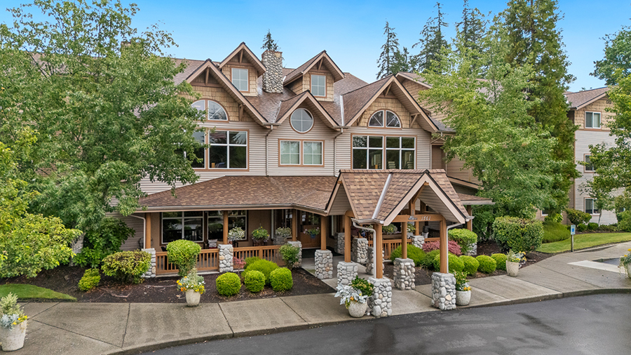 Charming multi-story home surrounded by lush greenery.