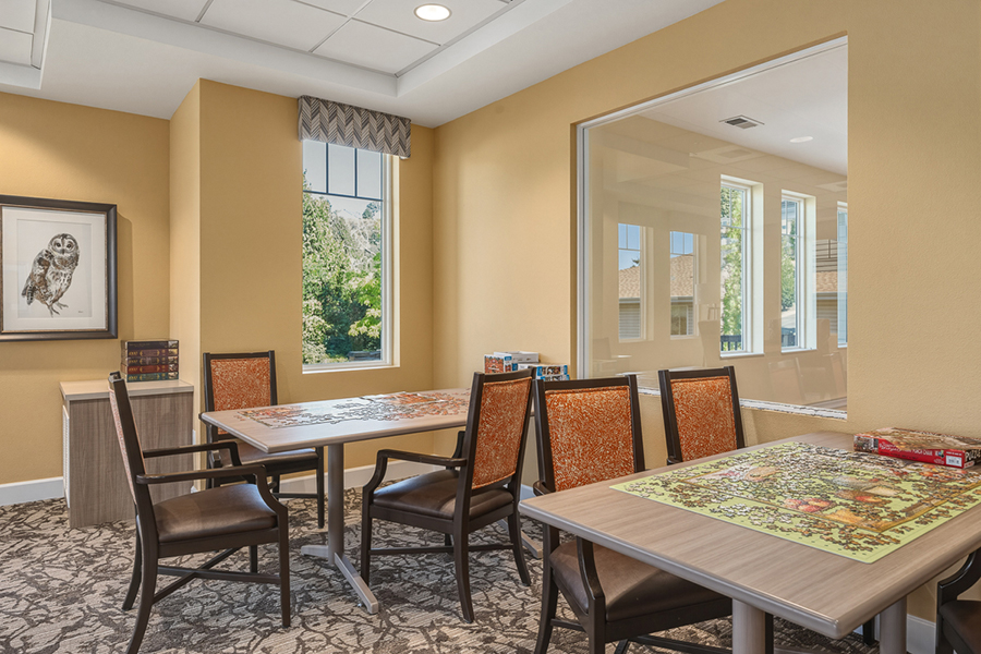 Bright room with tables for puzzles and games.