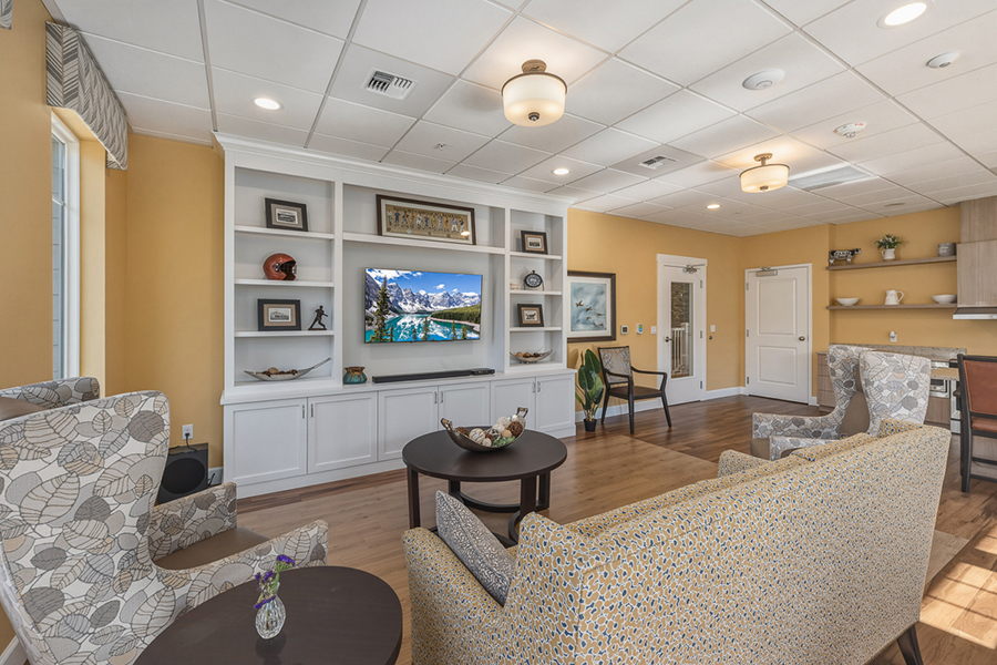 Cozy living space with seating and wall-mounted television.
