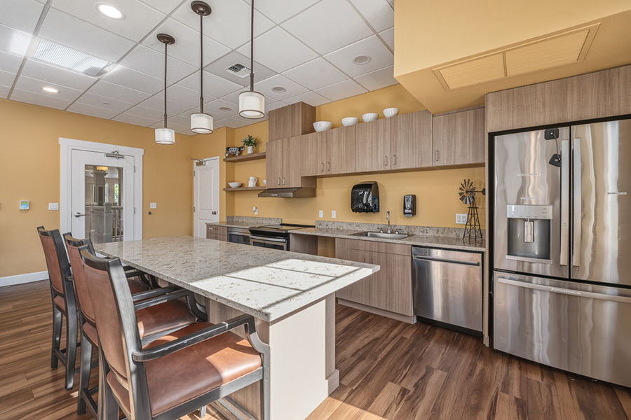 Modern kitchen with stainless steel appliances and wooden accents.