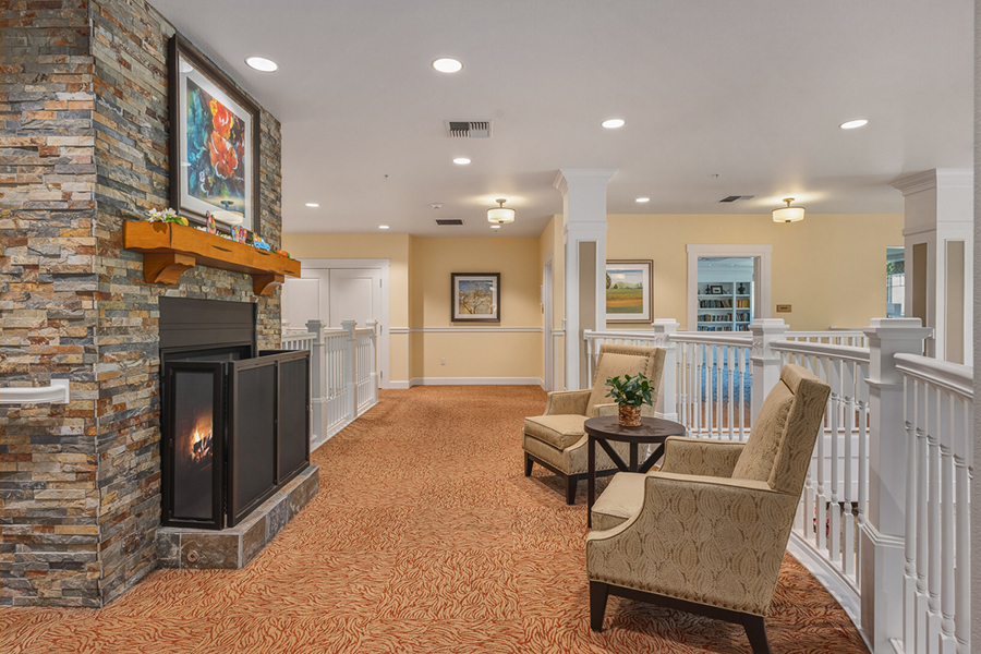 Cozy waiting area with fireplace and comfortable seating.