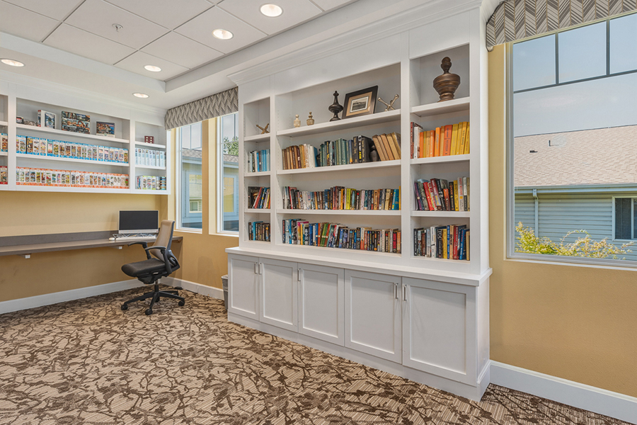 Cozy reading nook with bookshelves and workspace.