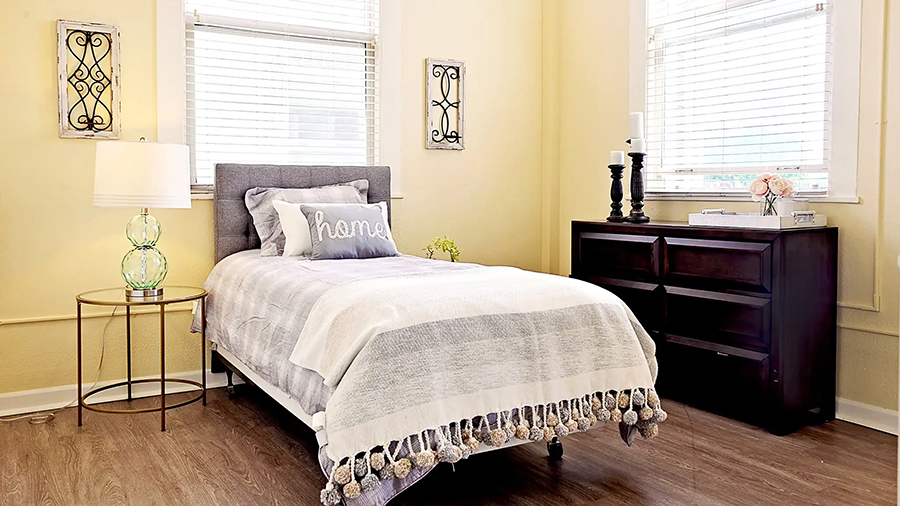 Cozy bedroom with simple decor and warm colors.