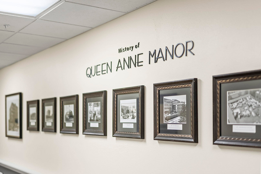 Gallery wall displaying historical photos of Queen Anne Manor.