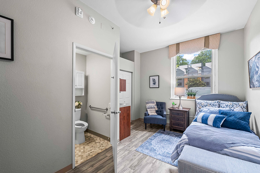 Cozy bedroom with attached bathroom and natural light.
