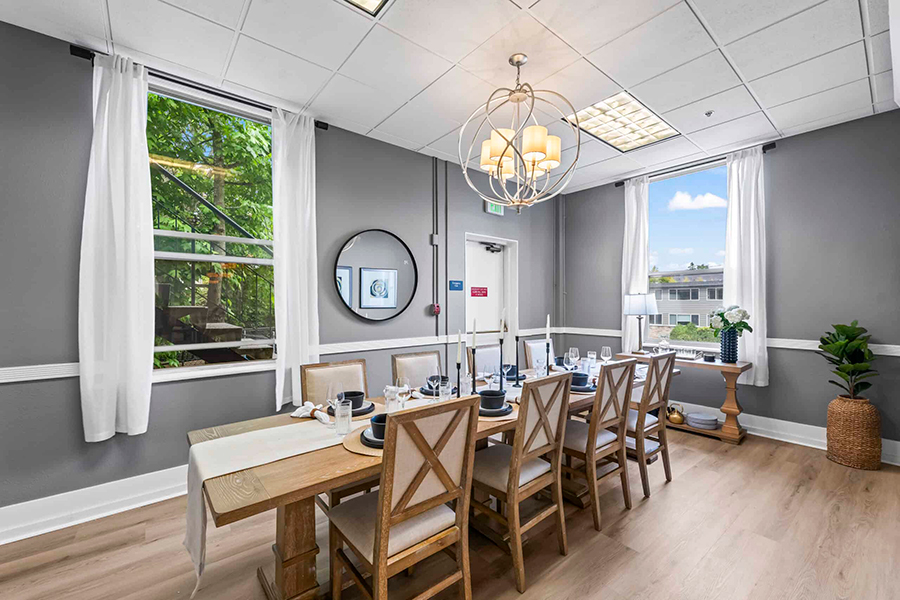 Elegant dining room with large table and natural light.