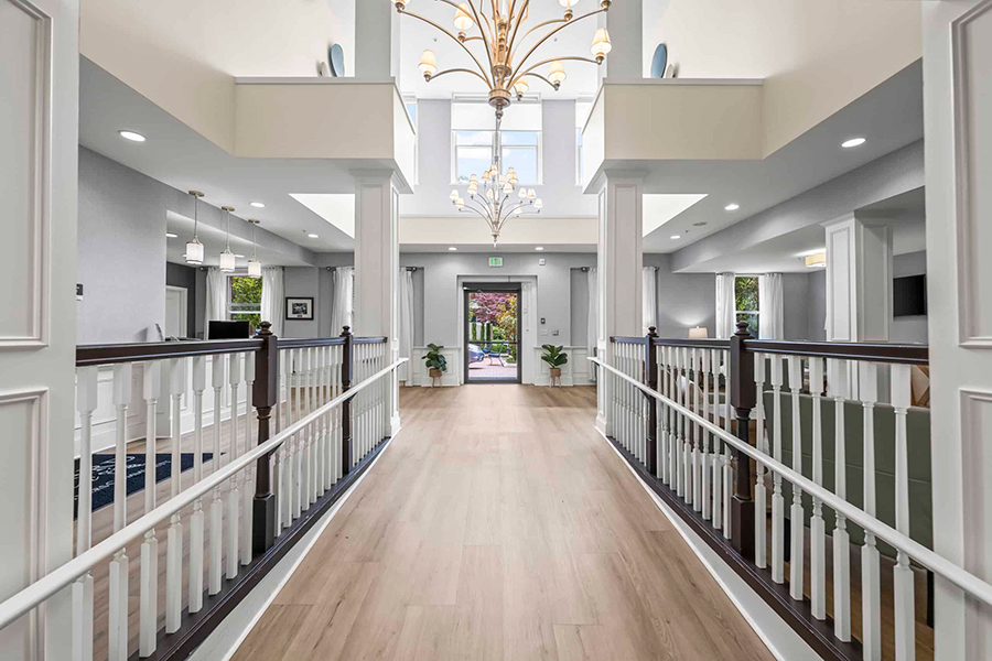 Spacious entryway with chandelier and modern decor.