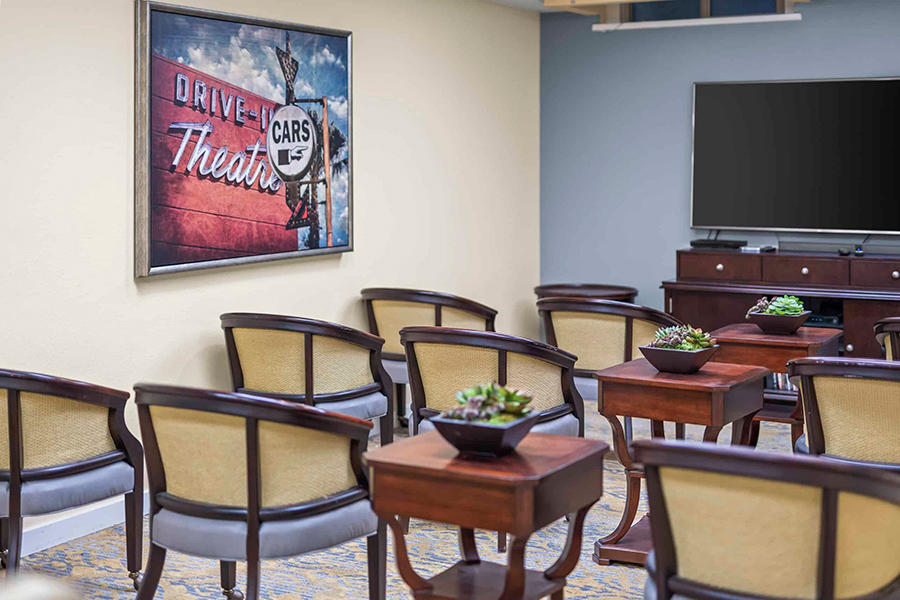 Meeting room with chairs, tables, and vintage decor.