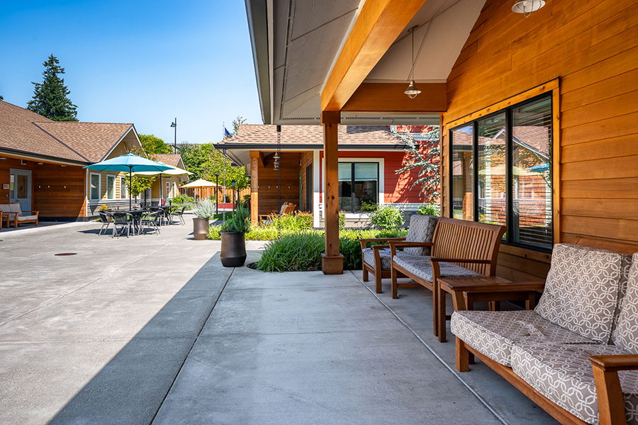 Outdoor seating area with wooden benches and sunny atmosphere.
