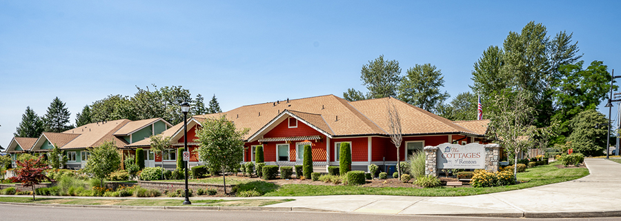 Cottages in a landscaped setting with clear blue sky.
