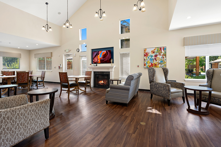 Bright, airy lounge with comfortable seating and a fireplace.