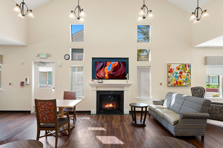 Cozy, bright lounge with fireplace and artwork.