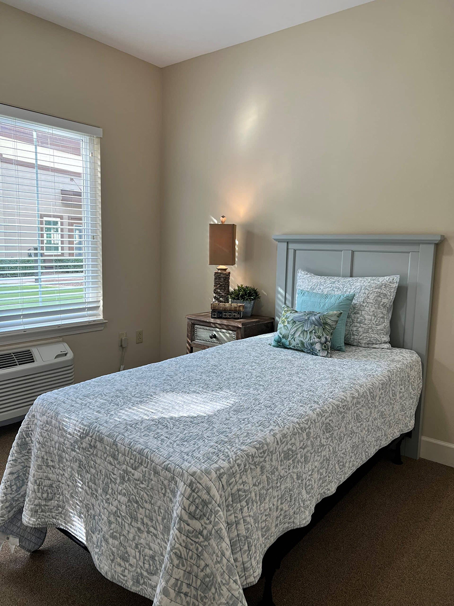 Cozy bedroom with single bed and natural light.