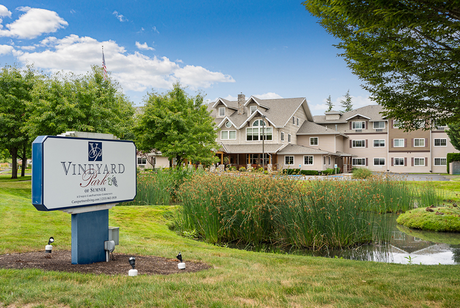 Vineyard Park: charming building near a serene pond.