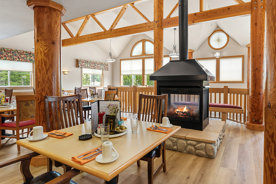 Cozy dining area with fireplace and wooden decor.