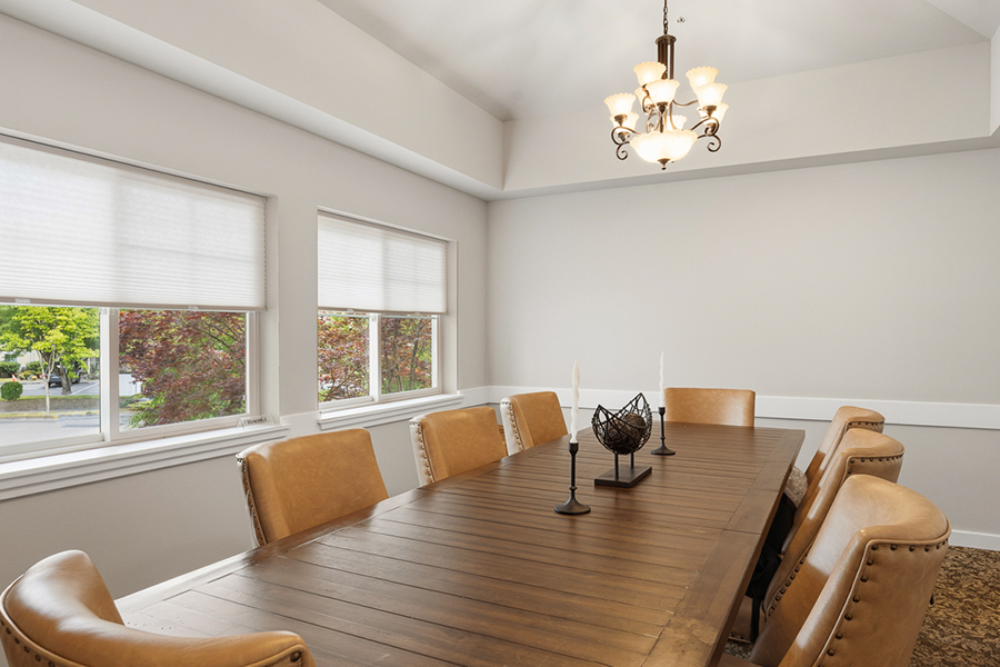 Modern dining room with large table and natural light.