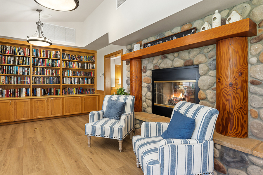 Cozy living room with bookshelves and a fireplace.