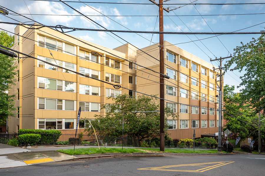 Residential building with trees and power lines in view.