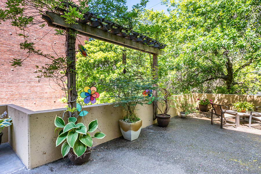 Outdoor patio with plants, decorations, and seating area.