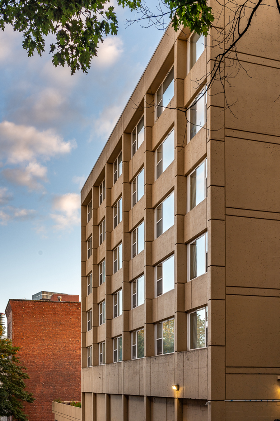 Modern building with multiple windows against a blue sky.