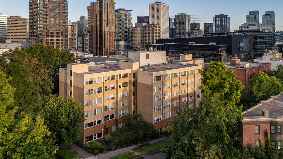 Urban landscape with buildings and greenery in the foreground.