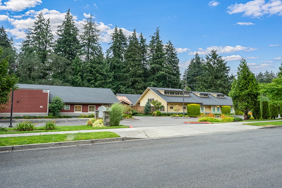 Quiet neighborhood with trees and charming buildings.