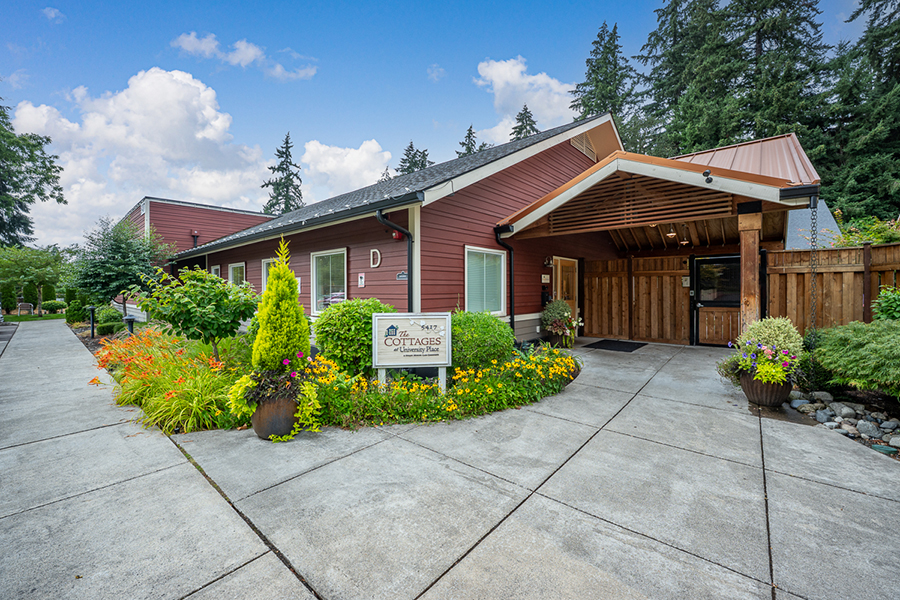 Charming cottage with flower gardens and welcoming entrance.