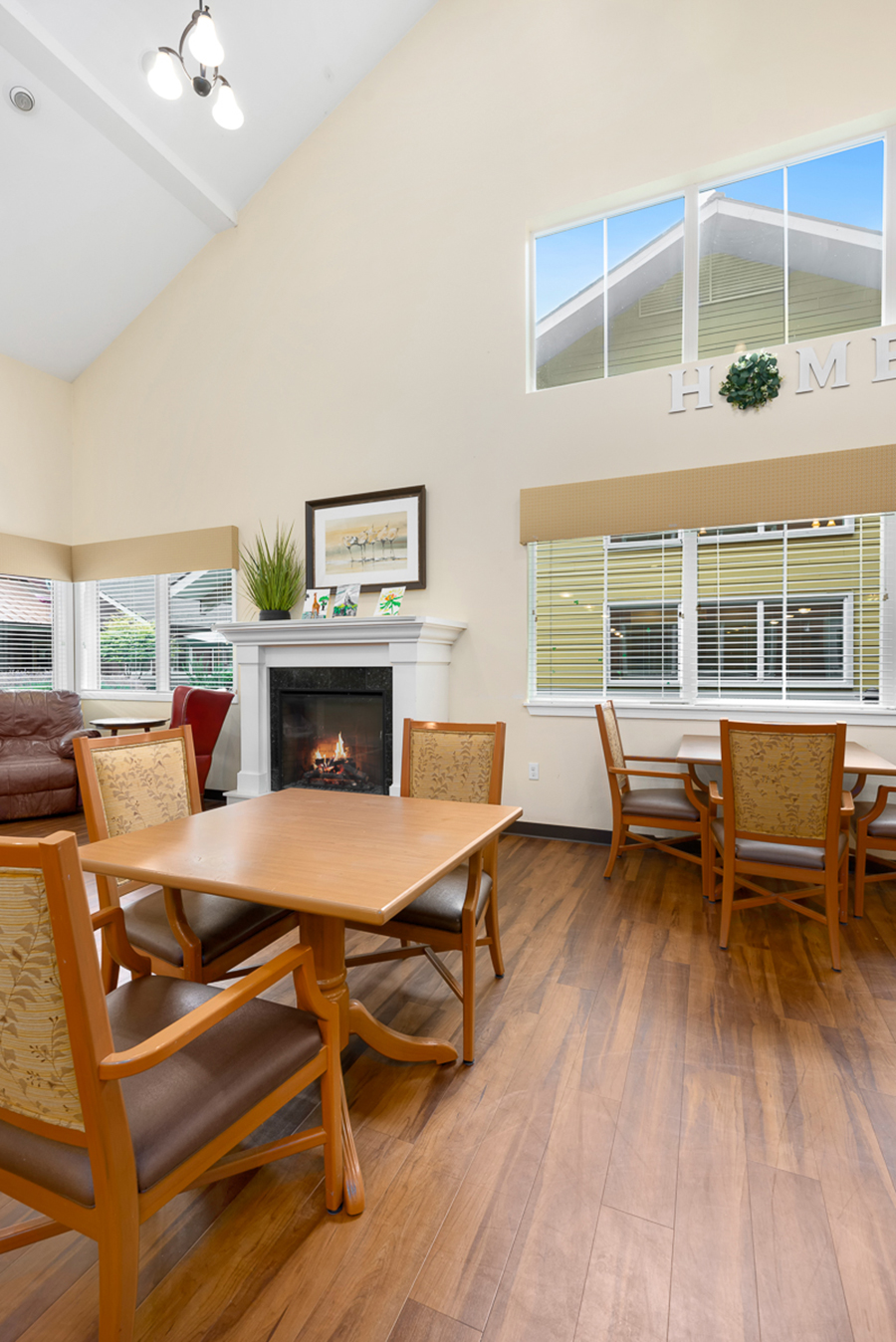 Cozy living area with fireplace and dining tables.