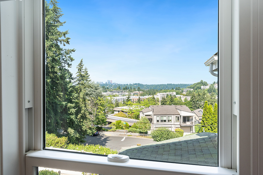 Clear view of greenery and buildings under a blue sky.