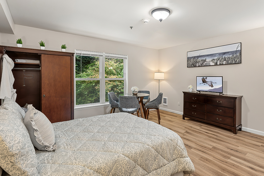 Cozy bedroom with modern amenities and natural lighting.