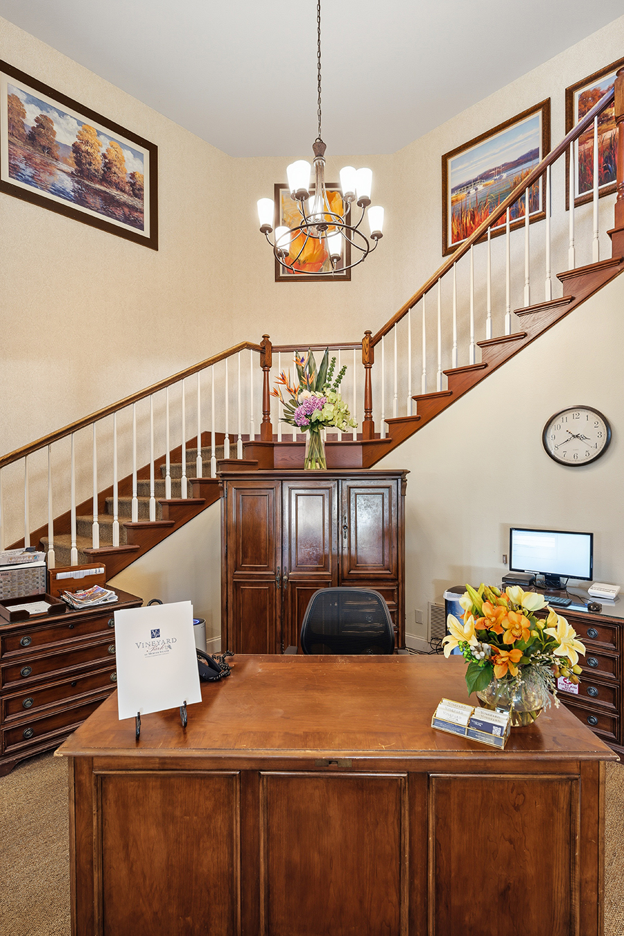 Welcoming reception area with floral arrangements and art.