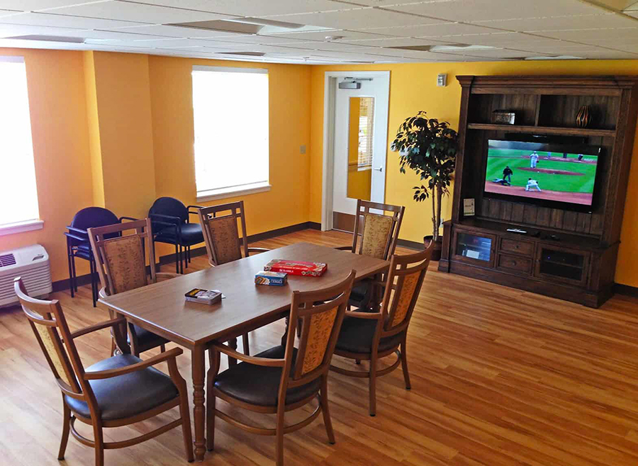 Cozy lounge with a table, chairs, and TV.