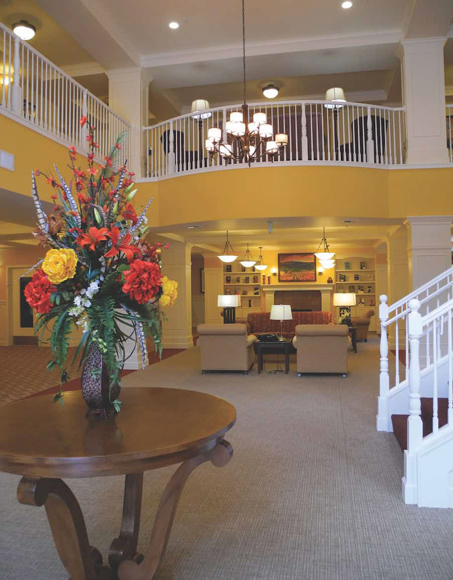 Spacious, elegant lobby with floral centerpiece and cozy seating.