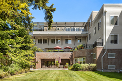 Modern building with terrace and landscaped garden.