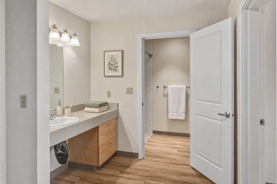 Modern bathroom with natural light and neutral colors.