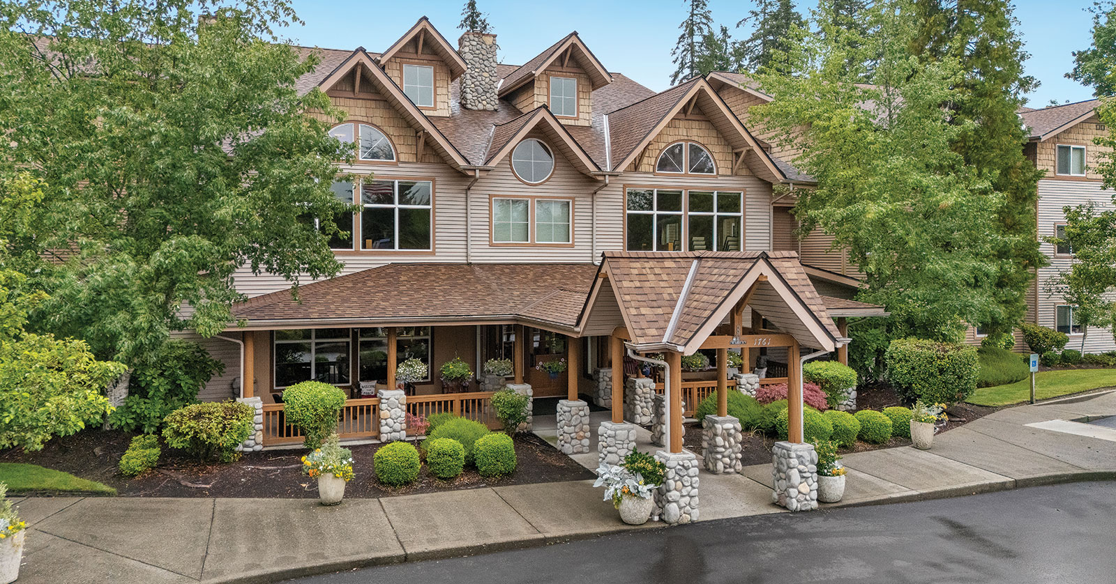 Charming building surrounded by greenery and landscaped pathways.