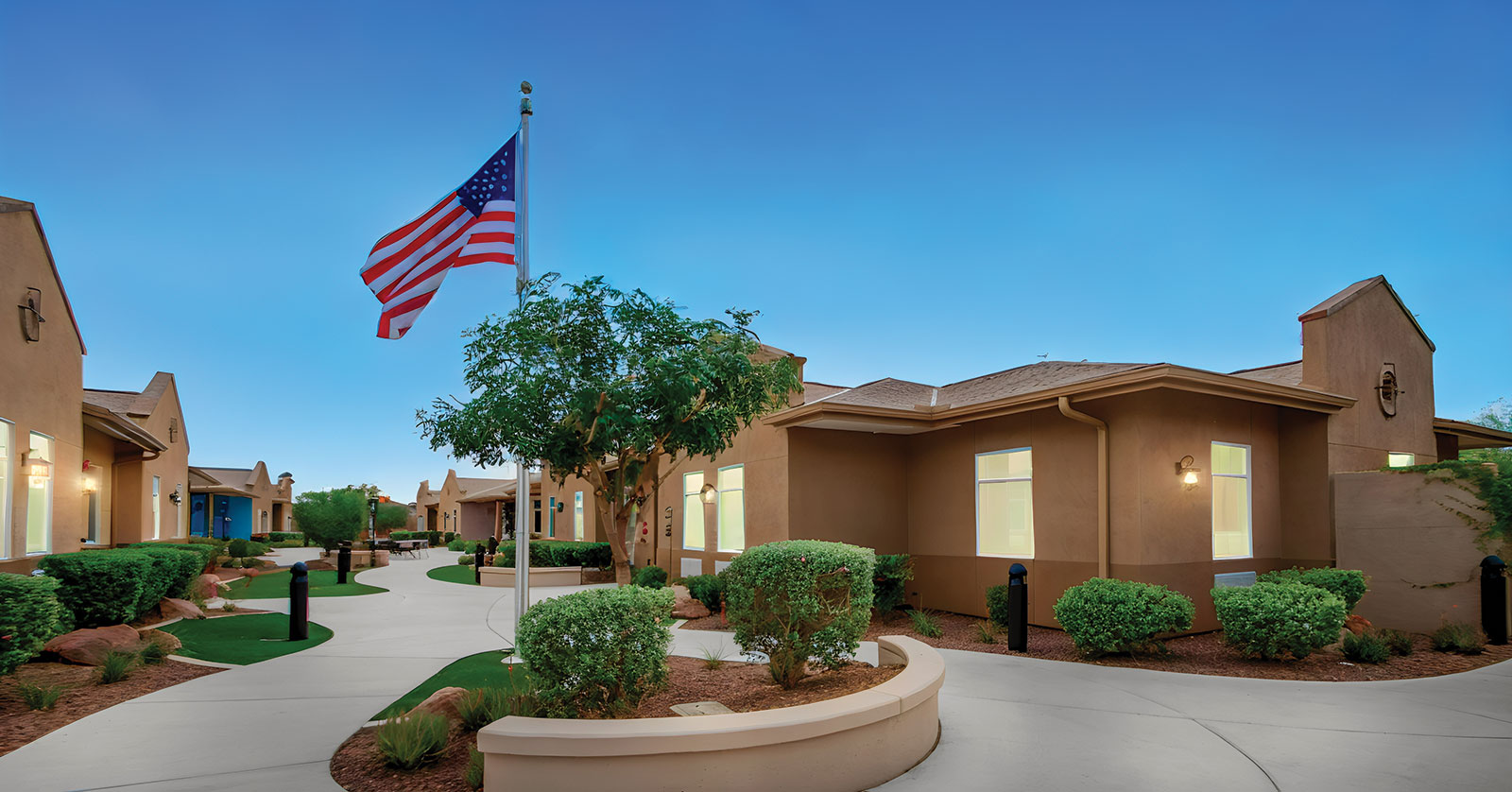 Residential area with landscaping and an American flag.