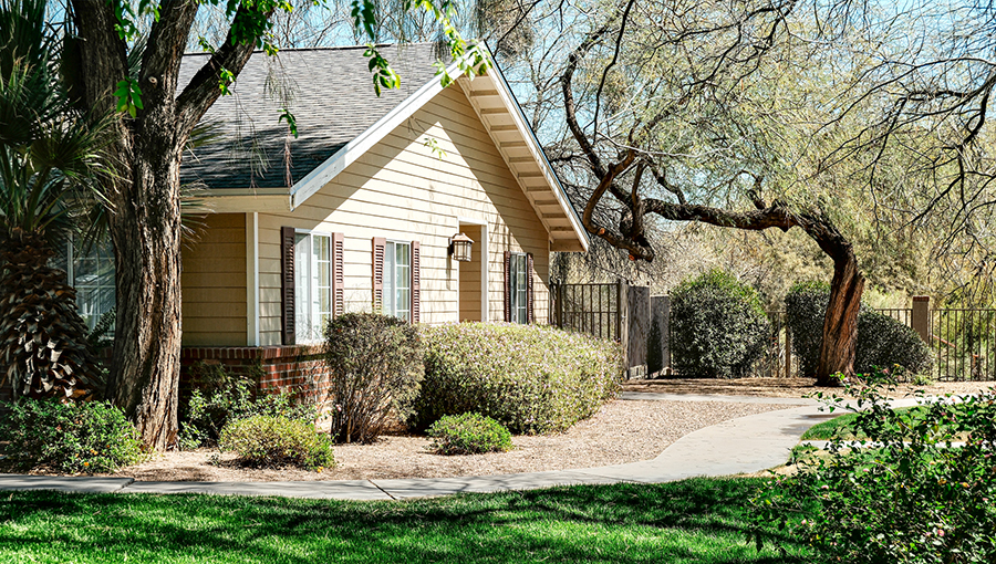 Charming house surrounded by greenery and trees.