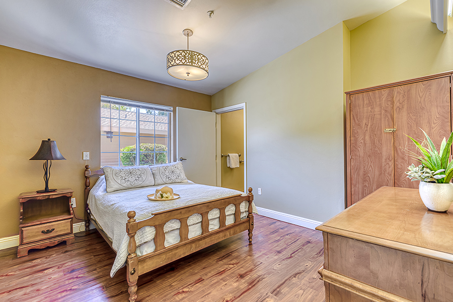 Cozy bedroom with wooden furniture and warm color scheme.